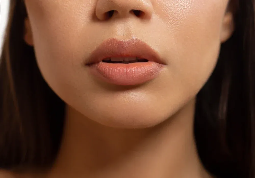 Client displays final healed lip tattoo results with stable natural color after complete recovery