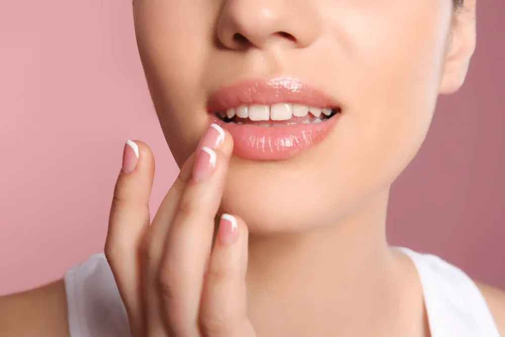 Satisfied client touches healed lips showing successful permanent makeup results after patient recovery