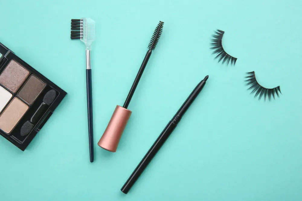 Eye makeup products like mascara and eyeliner, used to discuss the myth of wearing mascara with lash extensions.