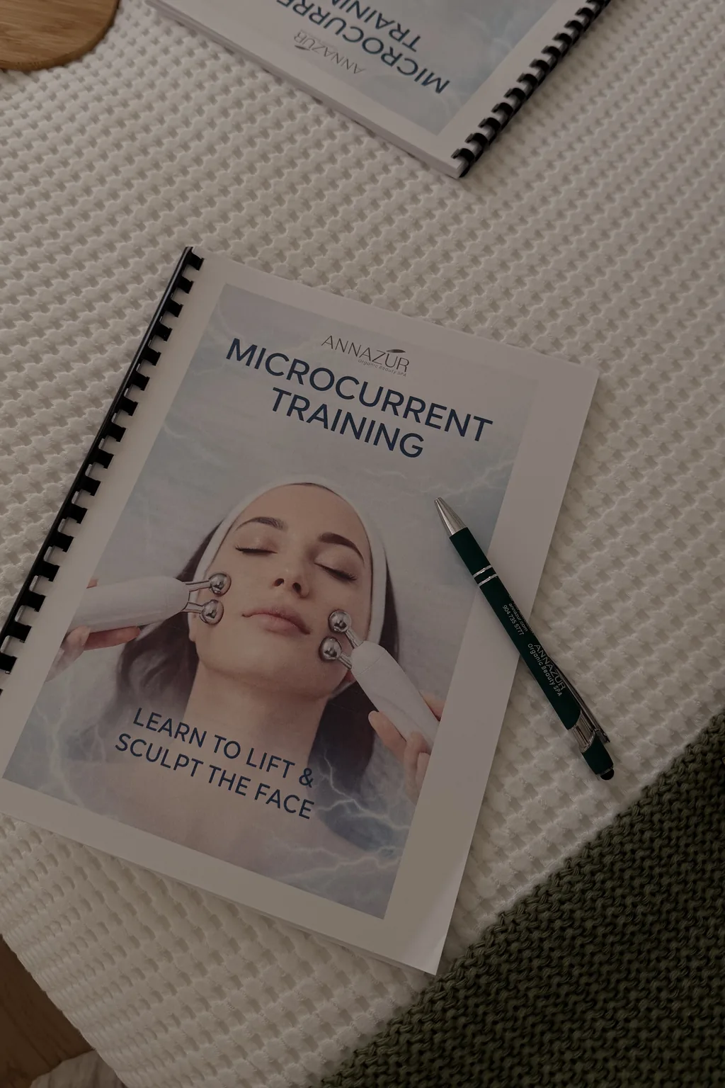 ANNAZUR Microcurrent Training workbook, Learn to Lift and Sculpt the Face, on a treatment surface