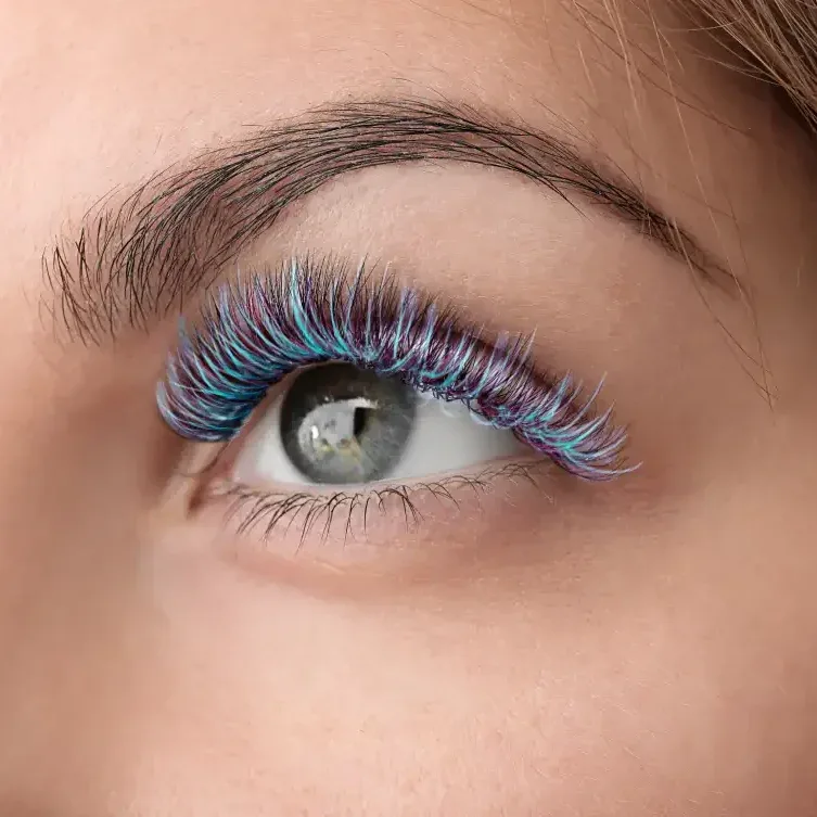Graduate wearing dramatic volume lash extensions with bold curls, creating impressive celebration day glamorous look