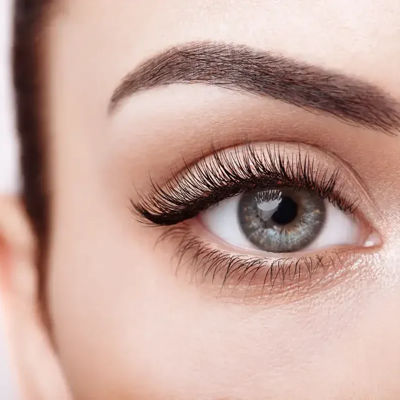 Woman wearing practical waterproof lash extensions with durable texture, enjoying carefree vacation swimming style